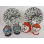A PAIR OF CHINESE FAMILLE VERTE DISHES painted with a scrolling dragon amongst foliage, 30cm
