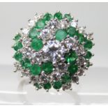 AN 18CT GOLD EMERALD AND DIAMOND CLUSTER RING set with estimated approx 1.22cts of brilliant cut