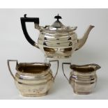 A THREE PIECE SILVER TEA SERVICE by William Aitken, Birmingham 1911, of rounded rectangular form