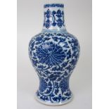 A CHINESE BLUE AND WHITE BALUSTER VASE painted with peony heads and scrolling foliage, 36cm high