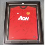 A RED MANCHESTER UNITED REPLICA SHORT-SLEEVED SHIRT the front bearing numerous player autographs