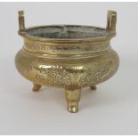 A CHINESE BRASS INCENSE BURNER with lug handles above a key pattern band and decorated with precious