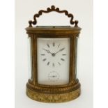 A 19TH CENTURY OVAL REPEATING CARRIAGE CLOCK striking on a bell, the white dial with Roman