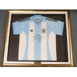 A BLUE AND WHITE ARGENTINA REPLICA SHORT-SLEEVED SHIRT the front autographed by Diego Maradona