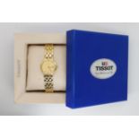 AN 18CT GOLD LADIES TISSOT WRISTWATCH with gold coloured dial and baton numerals, and date aperture,