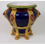 A MINTON MAJOLICA JARDINIERE modelled as a bowl supported by six hairy paw feet with six lion's mask