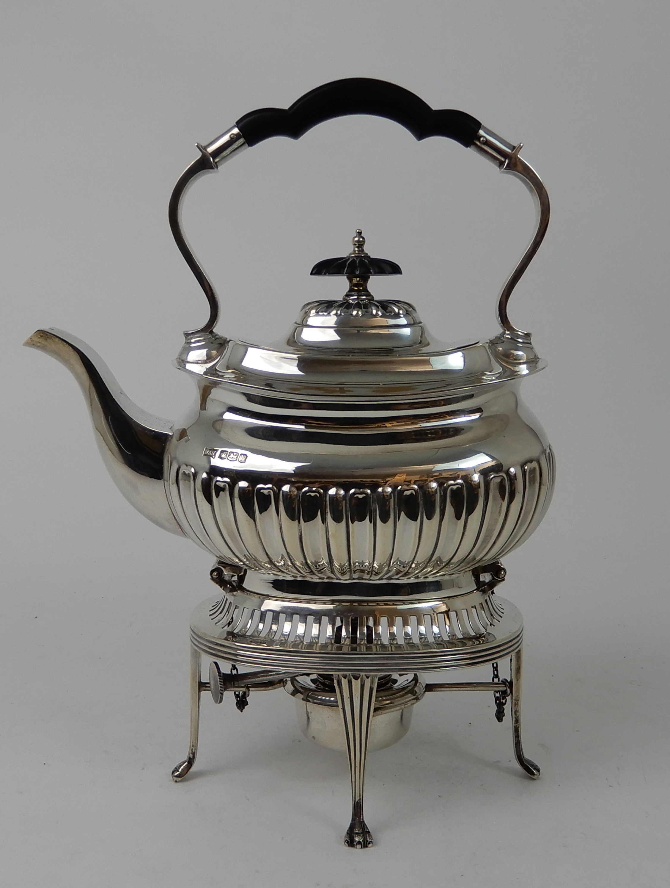 A SILVER SPIRIT KETTLE by Walker & Hall, Sheffield 1919, of curving rectangular form, with half