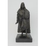 A BRONZED MODEL OF A MAN wearing fur trimmed robes, upon slate base, 46cm high Condition Report: