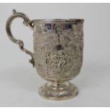 A SILVER TANKARD by James Weir, Glasgow 1891, of cylindrical form profusely embossed with putti