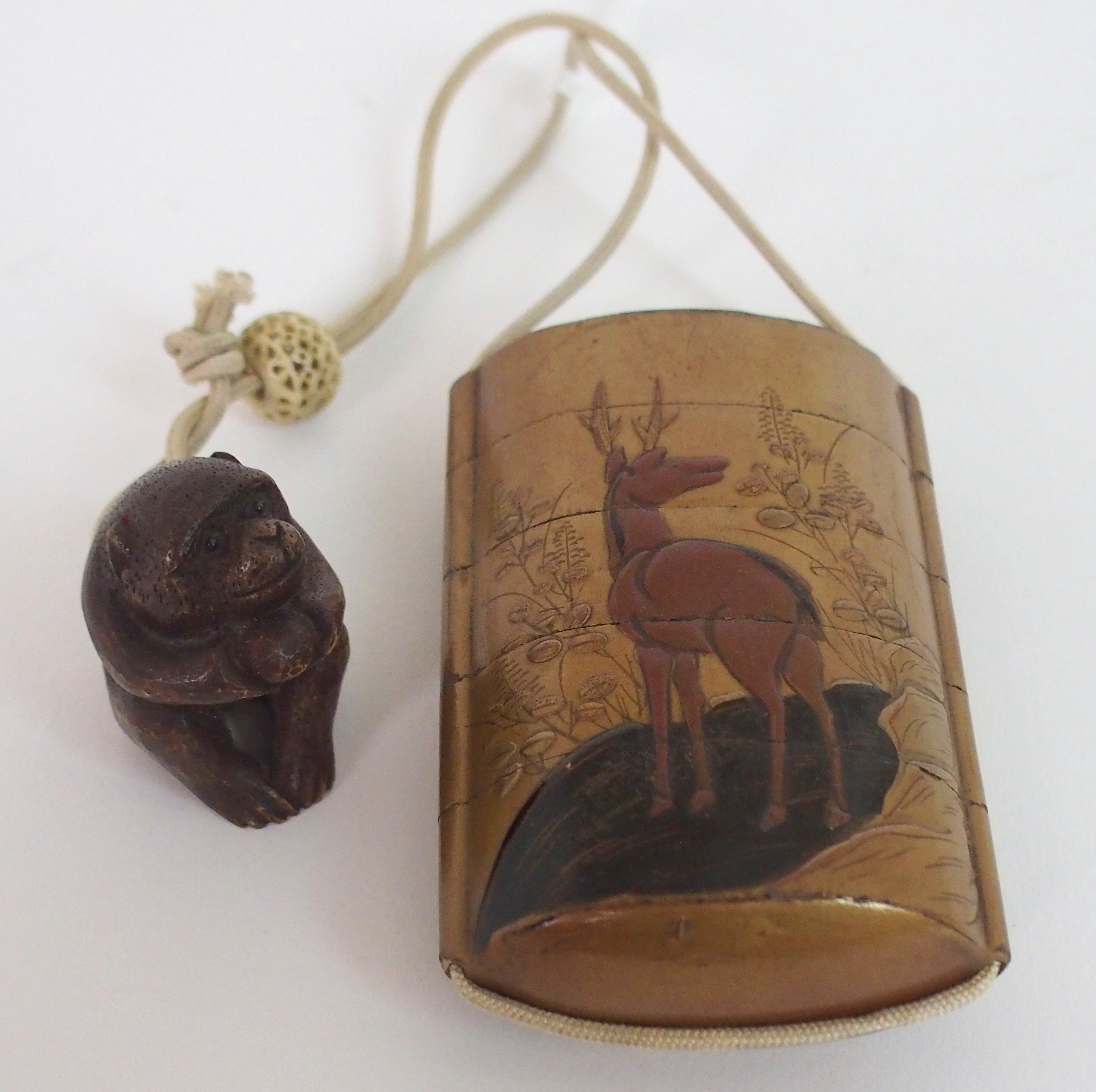 A JAPANESE FOUR-CASE INRO the gold laquered ground decorated with a deer, fitted with silk cord