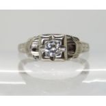AN 18K WHITE GOLD ART DECO DIAMOND RING with flower and leaf engraving to the mount and shank,