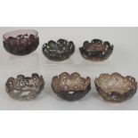 A SET OF SIX CHINESE SILVER FINGER BOWLS the pierced sides decorated with dragons amongst cloud
