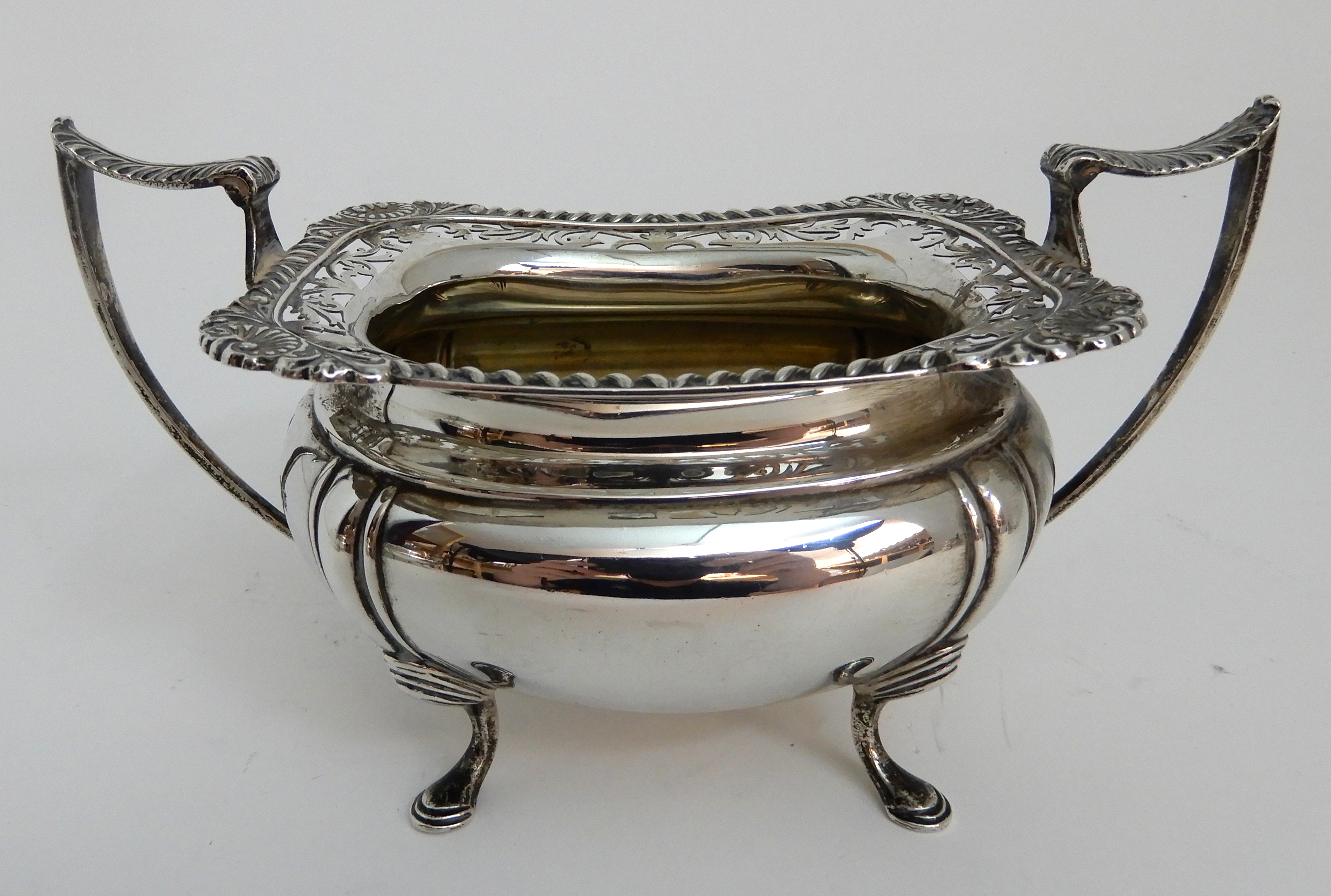A THREE PIECE SILVER TEA SERVICE by James Deakin & Son, Sheffield 1919, of rounded rectangular - Image 8 of 10