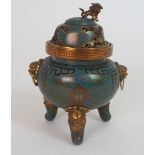 A CHINESE CLOISONNE INCENSE BURNER AND COVER with kylin finial above pierced foliage, grotesque mask