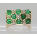 A 14K EMERALD AND DIAMOND RETRO DRESS RING