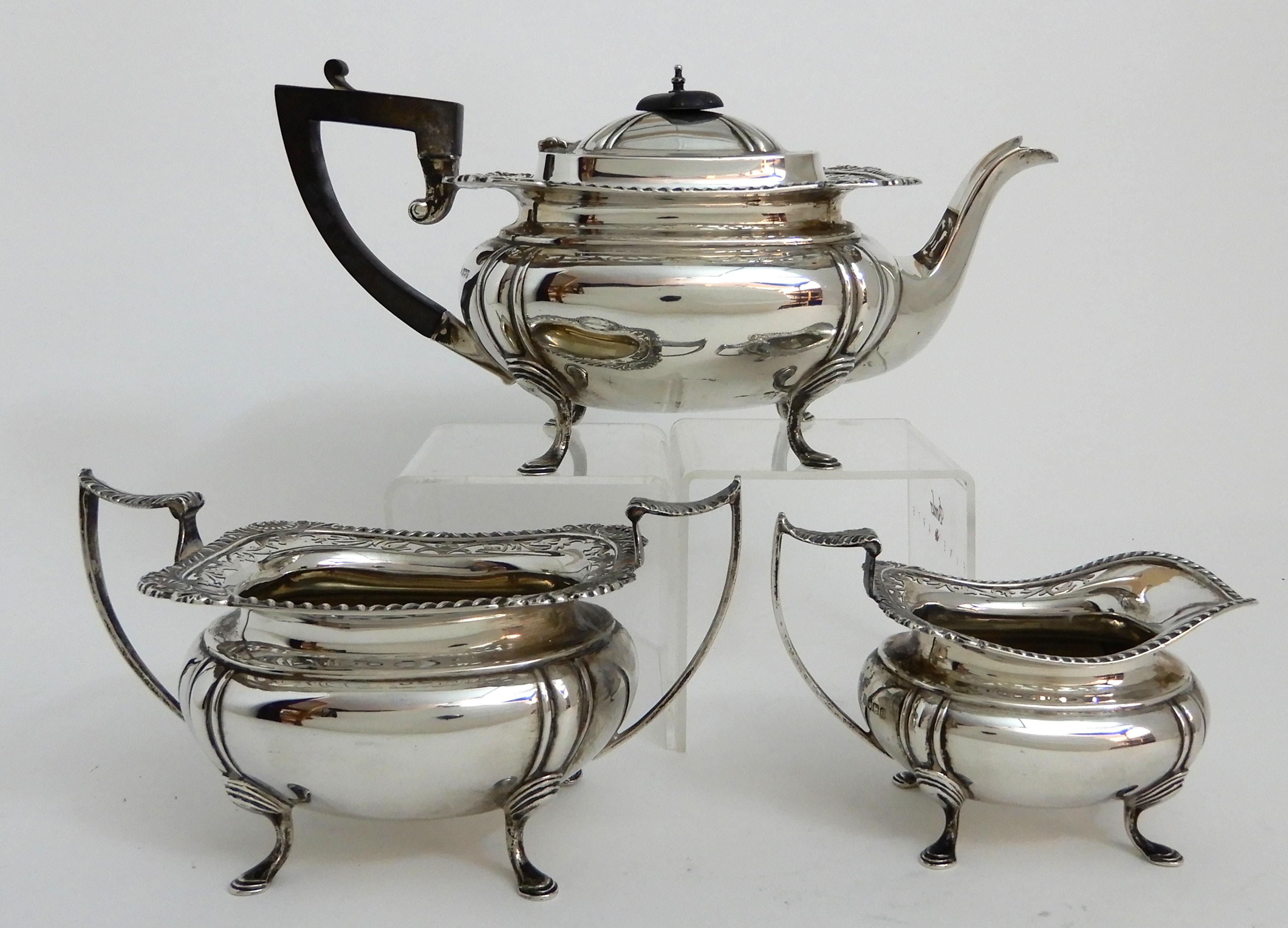 A THREE PIECE SILVER TEA SERVICE by James Deakin & Son, Sheffield 1919, of rounded rectangular