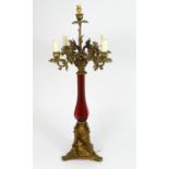AN ANTIQUE CANDELABRA TABLE LAMP with red glass vase shaped body with acorn and oak leaf moulded