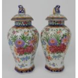 A PAIR OF SAMSON JARS AND COVERS each decorated with floral sprays and gilt decoration, 22cm high