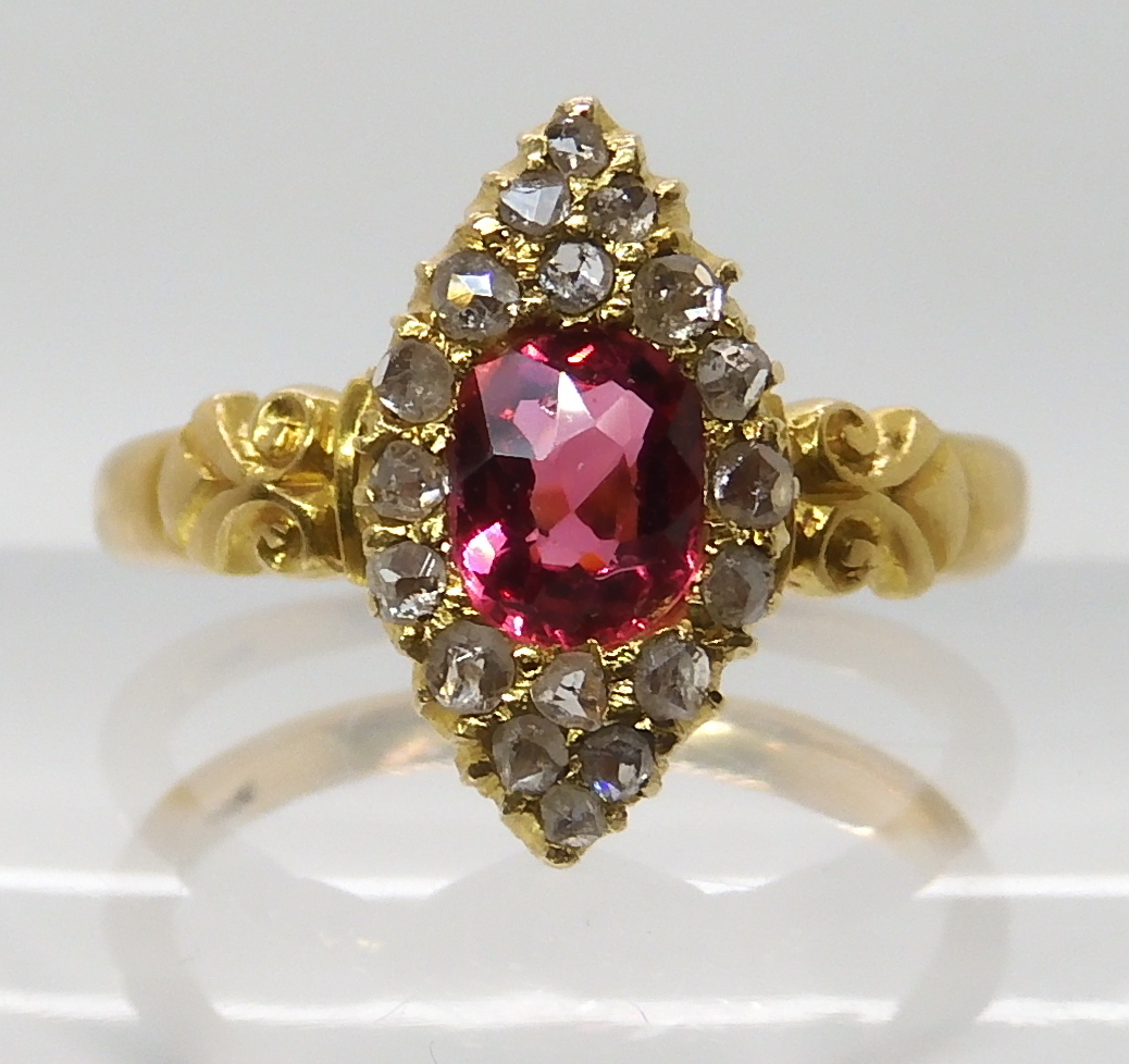 A YELLOW METAL ROSE CUT DIAMOND AND PINK GEM SET RING stamped 18 to the scroll shouldered