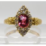 A YELLOW METAL ROSE CUT DIAMOND AND PINK GEM SET RING stamped 18 to the scroll shouldered