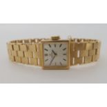 A LADIES 9CT GOLD RETRO OMEGA WRISTWATCH with integral block pattern strap, with square silvered