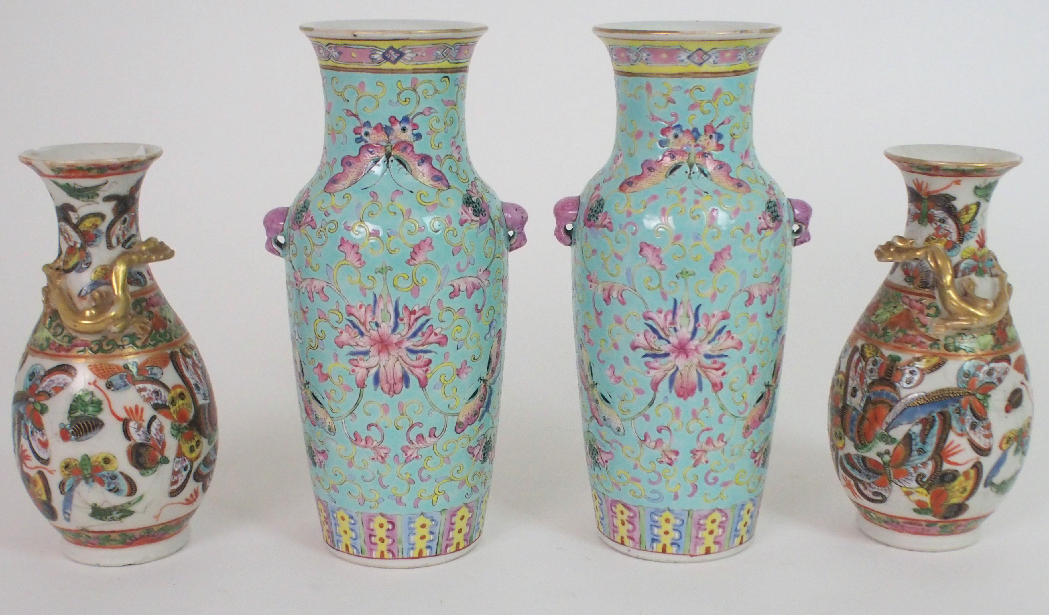 A PAIR OF CHINESE LILAC GROUND VASES paainted with butterflies, peonies and scrolling foliage,