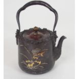 A JAPANESE IRON TETSUBIN naturalistically cast and decorated with a butterfly above gold and