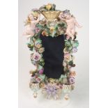 A MEISSEN STYLE WALL SCONCE decorated in relief with two cherubs and swags of colourful flowers,