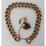 A 9CT GOLD CURB LINK BRACELET with heart shaped clasp, stamped 9c to every link, length 19.5cm,