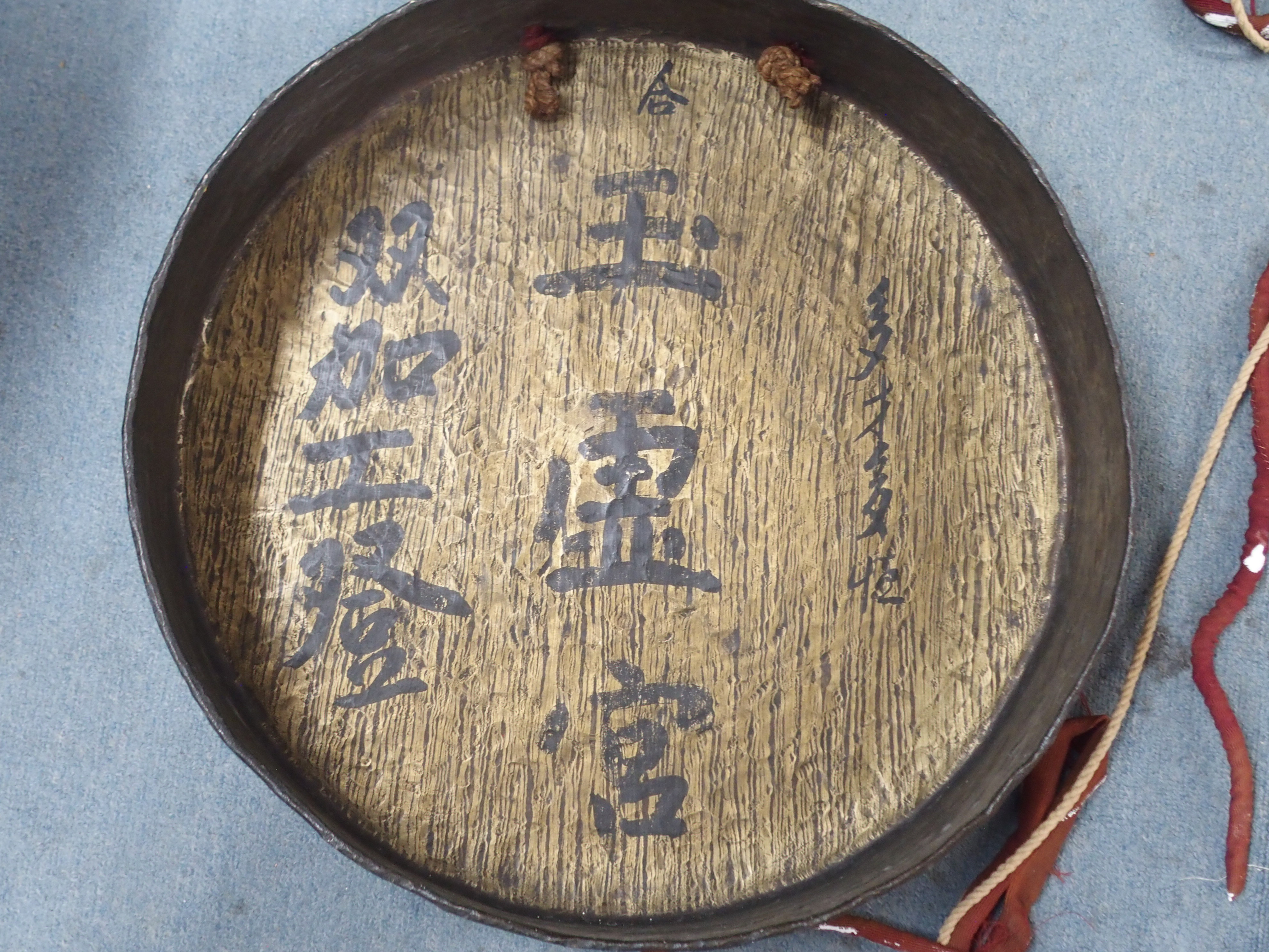 AN ASIAN BRASS GONG the hammered surface with deep rim, signed to the interior, with cord and - Image 3 of 5