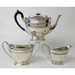 A THREE PIECE SILVER TEA SERVICE by James Ramsay, Sheffield 1917, of tapering rounded rectangular