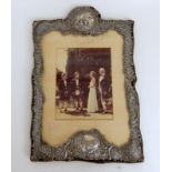 A SILVER MOUNTED PHOTO FRAME by Henry Matthews, Birmingham 1899, of rectangular form with foliate