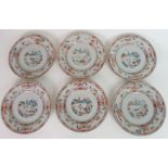 A SET OF SIX CHINESE EXPORT PLATES each painted with landscape roundels, within bands of trellis and