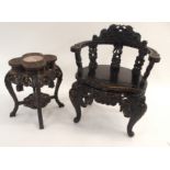 A CHINESE EBONISED ARMCHAIR the back rest carved with dragons above curved arms, supported on five