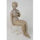 WALTER AWLSON (SCOTTISH b 1949) A SEATED FEMALE NUDE in bisque coloured glaze, 24cm high, signed