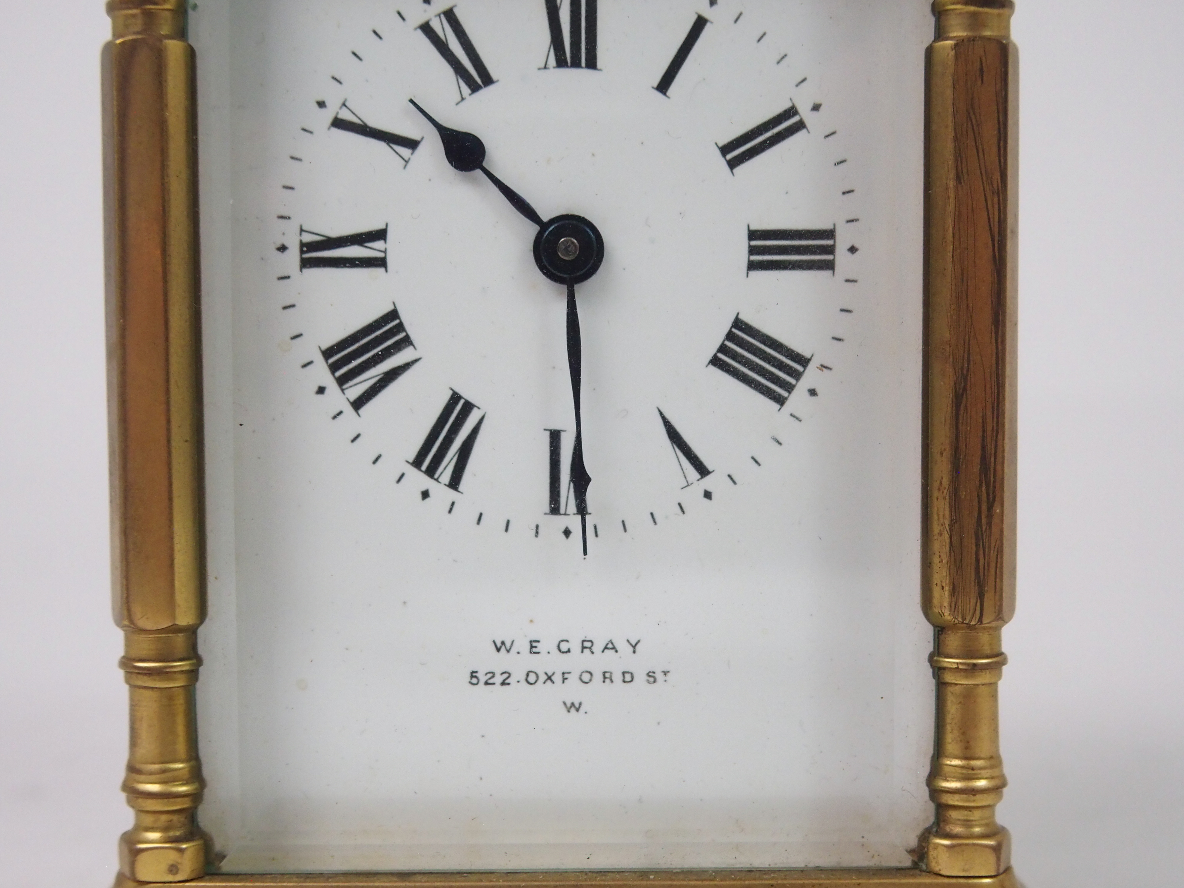 A FRENCH BRASS AND GLASS CARRIAGE CLOCK the white enamel dial with Roman Numerals, retailed by W. - Image 2 of 8