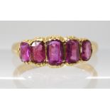 A BRIGHT YELLOW FIVE STONE RUBY RING each in a cut back clawed setting, largest ruby approx 5mm x