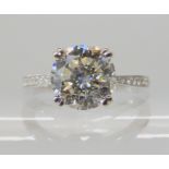 AN 18CT WHITE GOLD DIAMOND SOLITAIRE RING the main diamond is estimated approximately to be just
