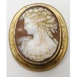 A YELLOW METAL MOUNTED SHELL CAMEO BROOCH OF A MAIDEN with flower engraved frame, dimensions of