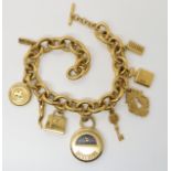 A MOSCHINO TIME PENDANT WATCH BRACELET gold plated with further Moschino charms, the back of the