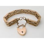 A 9CT GOLD DECORATIVE GATE BRACELET with heart shaped clasp. Length 19cm, weight 24.5gms Condition