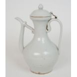 AN ASIAN WHITE GLAZED EWER with domed cover joined by wire attachment by small lugs, with scroll