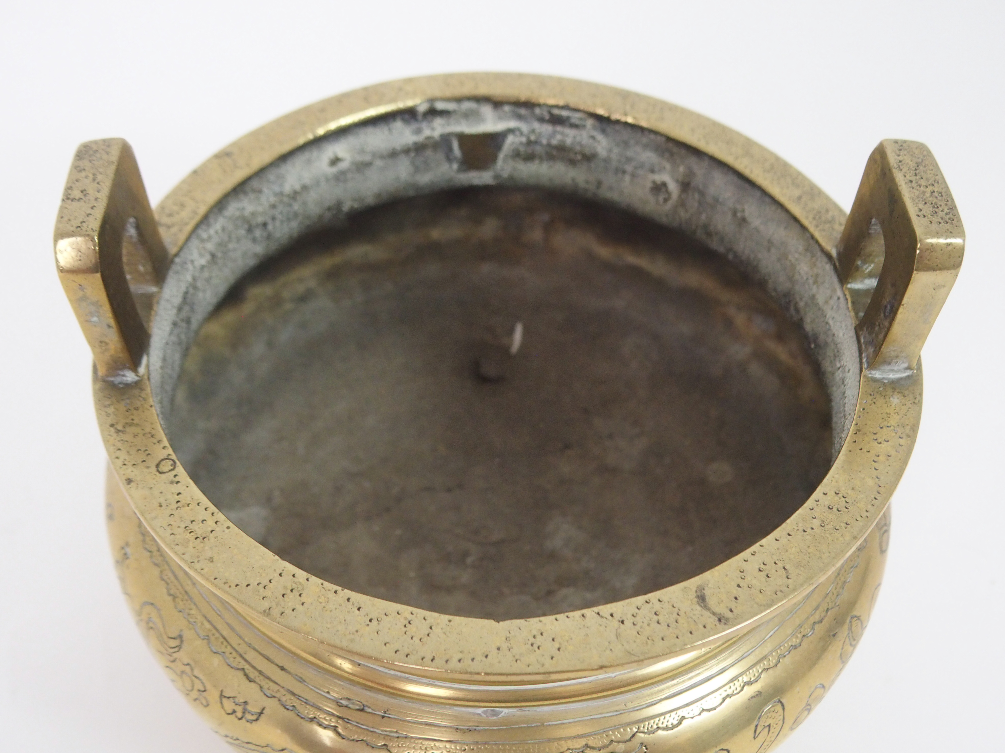A CHINESE BRASS INCENSE BURNER with lug handles above a key pattern band and decorated with precious - Image 4 of 6