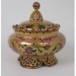 A ZOLNAY PECS LIDDED POT the brown glazed body with gilt scrollwork and flower decoration, with