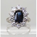 AN 18CT WHITE GOLD SAPPHIRE AND DIAMOND CLUSTER RING the octagonal cut sapphire has the approx