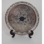 A CHINESE SILVER CIRCULAR TRAY the pierced border decorated with bamboo, above a central design of