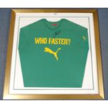 A GREEN PUMA WHO FASTER T-SHIRT the front autographed by Usain Bolt, framed and glazed, 85 x 85cm