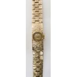 A RETRO 9CT GOLD LADIES BUECHE GIROD WRISTWATCH with bark texture throughout, gold coloured dial,