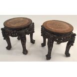 A PAIR OF CHINESE HARDWOOD CIRCULAR PEDESTAL TABLES inset with marble tops above pierced foliate