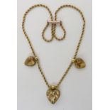 A VINTAGE CITRINE HEART NECKLACE mounted on a yellow metal rope chain, largest citrine approx 12.5mm